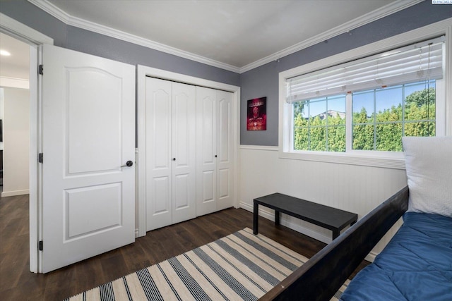 10219 W Argent Rd, Pasco, WA 99301 - bedroom featuring dark wood-type flooring, ornamental molding, a wainscoted wall, and a closet