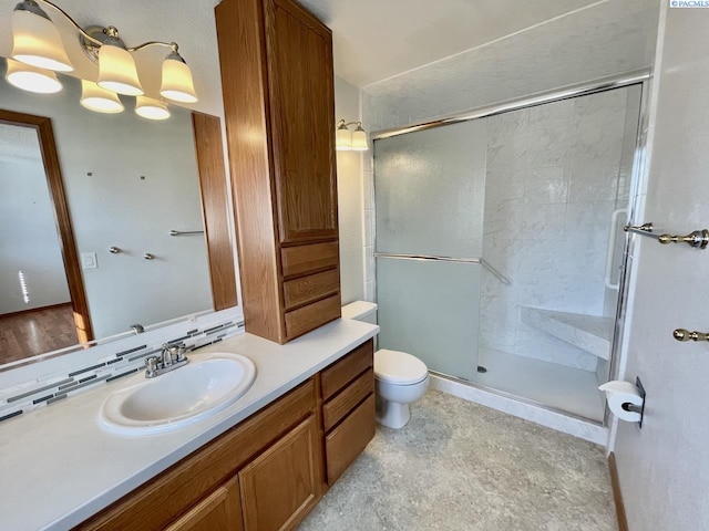 full bath featuring toilet, a shower stall, and vanity