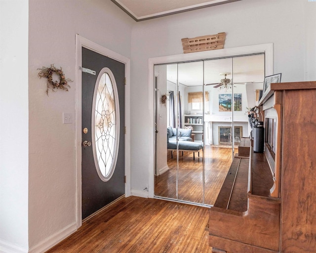 807 S Mill St, Colfax, WA 99111 - foyer entrance with a glass covered fireplace, wood finished floors, baseboards, and plenty of natural light