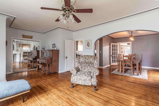 807 S Mill St, Colfax, WA 99111 - sitting room featuring arched walkways, ceiling fan, wood finished floors, and baseboards