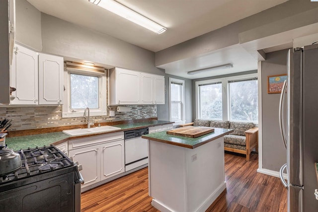 807 S Mill St, Colfax, WA 99111 - kitchen featuring freestanding refrigerator, white dishwasher, a sink, tasteful backsplash, and lofted ceiling