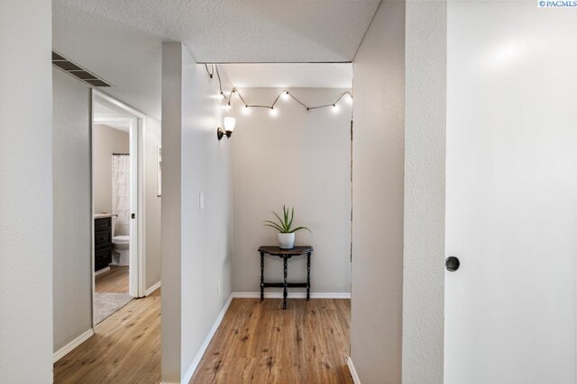 2913 W John Day Ave Unit D102, Kennewick, WA 99336 - hallway with light wood-type flooring, baseboards, and rail lighting