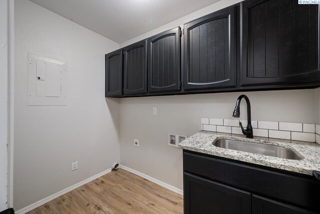 2913 W John Day Ave Unit D102, Kennewick, WA 99336 - laundry room with washer hookup, cabinet space, electric panel, light wood-type flooring, and baseboards