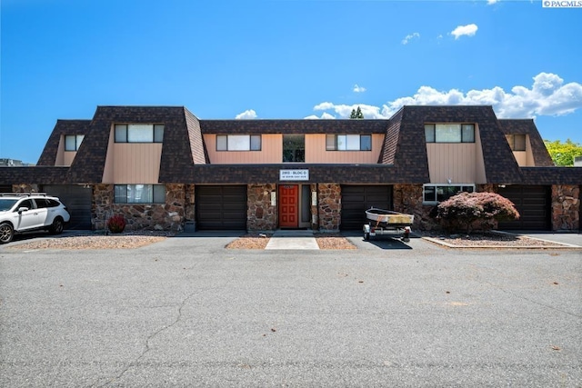 2913 W John Day Ave Unit D102, Kennewick, WA 99336 - view of front of house featuring stone siding and mansard roof