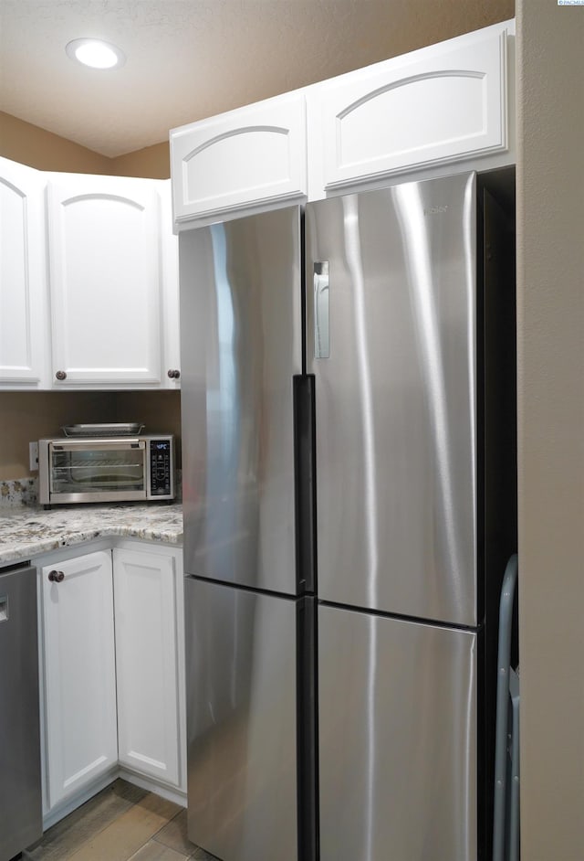 1135 SW Lost Trail Dr, Pullman, WA 99163 - kitchen with stainless steel appliances, white cabinetry, light stone countertops, and recessed lighting