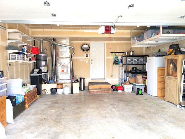 1135 SW Lost Trail Dr, Pullman, WA 99163 - garage with a garage door opener, secured water heater, and freestanding refrigerator