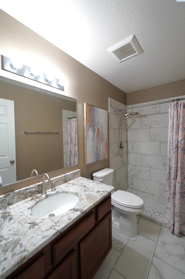 1135 SW Lost Trail Dr, Pullman, WA 99163 - full bath featuring vanity, marble look tiles, tiled shower, and a textured ceiling