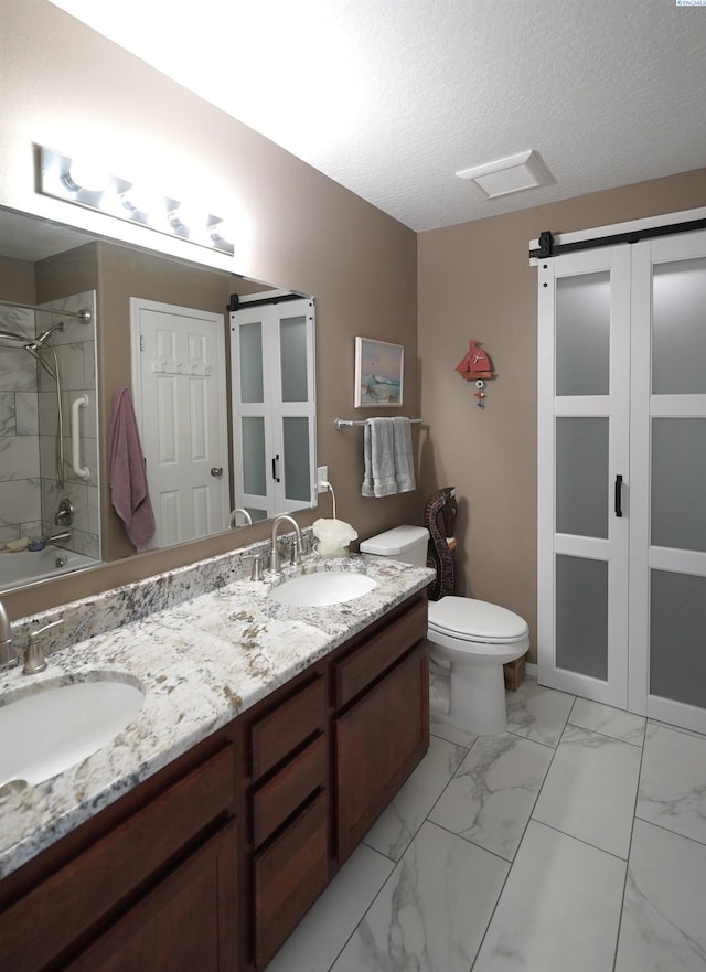 1135 SW Lost Trail Dr, Pullman, WA 99163 - full bath featuring double vanity, marble finish floors, and a textured ceiling