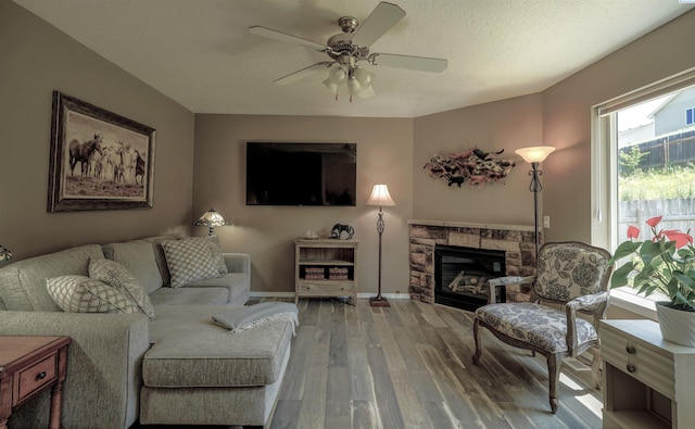 1135 SW Lost Trail Dr, Pullman, WA 99163 - living room with wood finished floors, a ceiling fan, and a fireplace