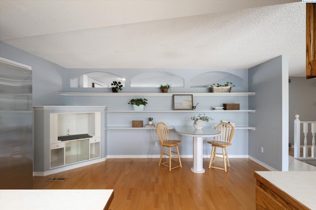2714 W John Day Ave, Kennewick, WA 99336 - dining room with light wood-style flooring and a textured ceiling