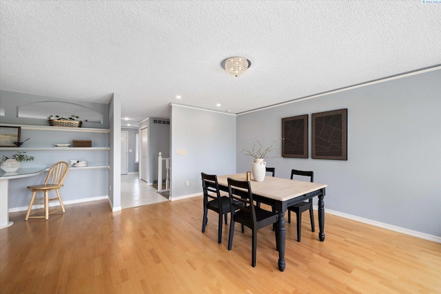 2714 W John Day Ave, Kennewick, WA 99336 - dining room with a textured ceiling, light wood-style floors, baseboards, recessed lighting, and ornamental molding