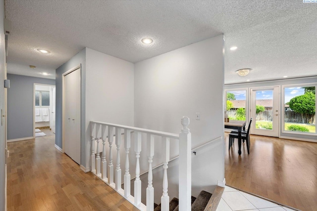 2714 W John Day Ave, Kennewick, WA 99336 - hall featuring an upstairs landing, a textured ceiling, light wood finished floors, recessed lighting, and baseboards