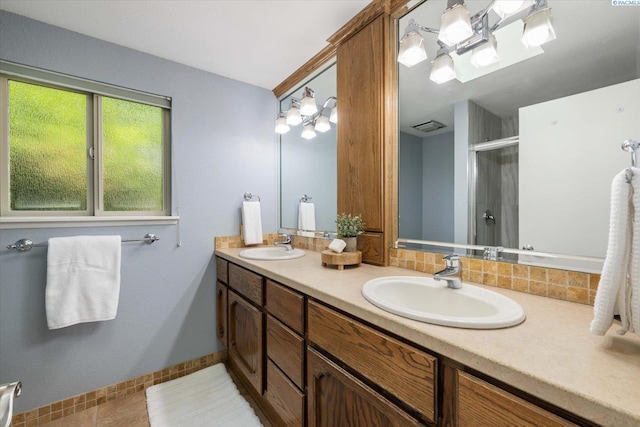 2714 W John Day Ave, Kennewick, WA 99336 - full bathroom featuring a stall shower, double vanity, baseboards, and tile patterned floors