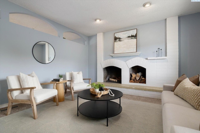 2714 W John Day Ave, Kennewick, WA 99336 - living room with light colored carpet, a brick fireplace, and a textured ceiling