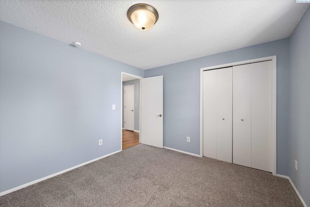 2714 W John Day Ave, Kennewick, WA 99336 - unfurnished bedroom featuring carpet, a closet, a textured ceiling, and baseboards