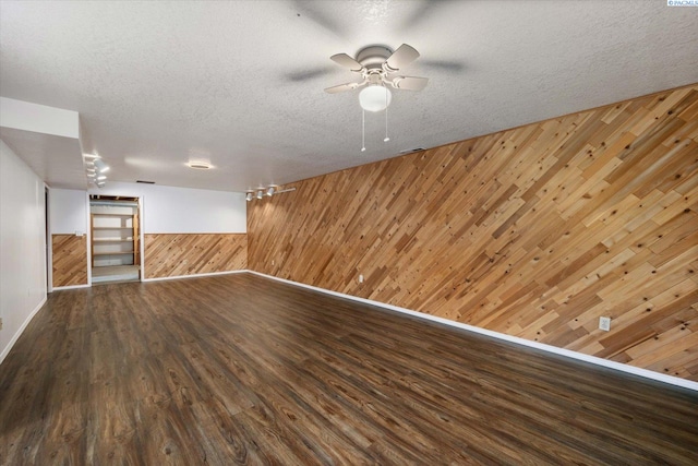 2714 W John Day Ave, Kennewick, WA 99336 - below grade area featuring wood walls, wood finished floors, baseboards, a textured ceiling, and ceiling fan