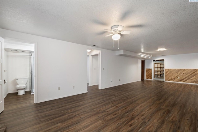 2714 W John Day Ave, Kennewick, WA 99336 - unfurnished living room with a ceiling fan, dark wood-style flooring, a textured ceiling, and baseboards