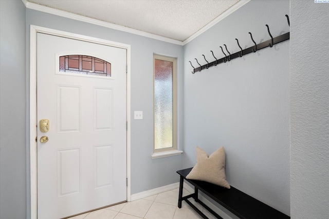 2714 W John Day Ave, Kennewick, WA 99336 - entryway with crown molding, healthy amount of natural light, light tile patterned flooring, a textured ceiling, and baseboards