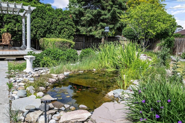 2714 W John Day Ave, Kennewick, WA 99336 - view of yard with fence, a garden pond, a pergola, and a deck