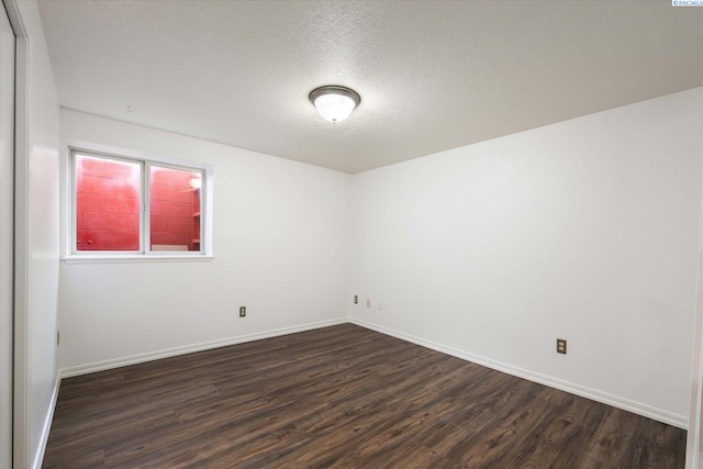 2714 W John Day Ave, Kennewick, WA 99336 - unfurnished room with dark wood-type flooring, baseboards, and a textured ceiling