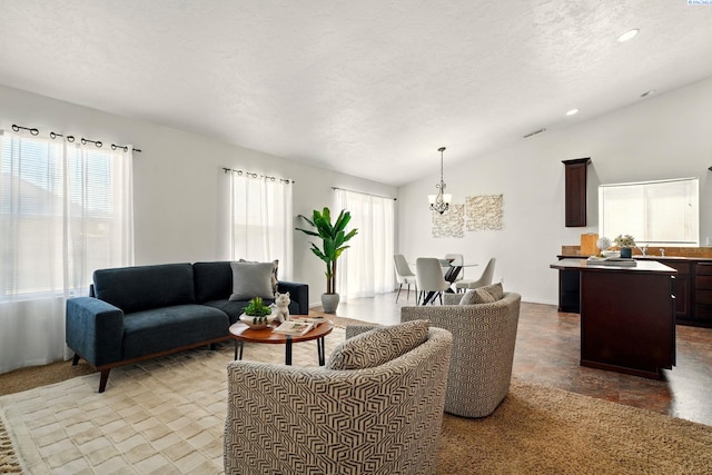 5725 Sidon Ln, Pasco, WA 99301 - living room featuring a chandelier, lofted ceiling, a textured ceiling, and recessed lighting