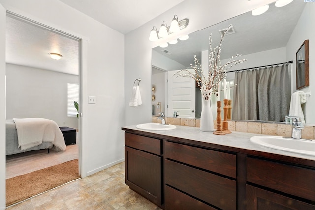 5725 Sidon Ln, Pasco, WA 99301 - ensuite bathroom with double vanity, a chandelier, and baseboards