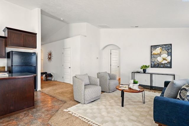 5725 Sidon Ln, Pasco, WA 99301 - living room with lofted ceiling, arched walkways, and light stone finish floors