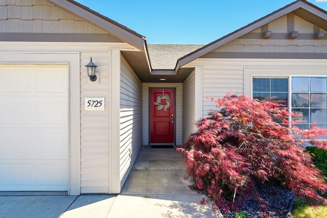 5725 Sidon Ln, Pasco, WA 99301 - property entrance featuring a garage and roof with shingles