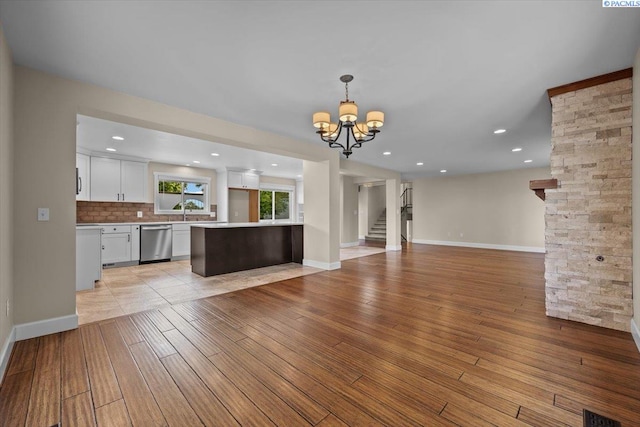 707 N Quillan St, Kennewick, WA 99336 - unfurnished living room with a chandelier, light wood-style floors, recessed lighting, and stairway