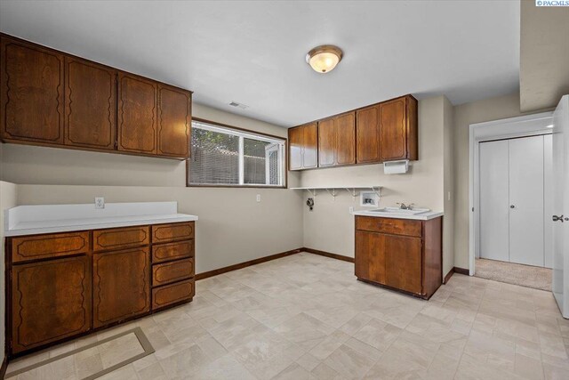707 N Quillan St, Kennewick, WA 99336 - kitchen featuring light countertops and brown cabinets