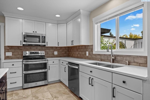 707 N Quillan St, Kennewick, WA 99336 - kitchen featuring stainless steel appliances, light countertops, decorative backsplash, white cabinets, and recessed lighting