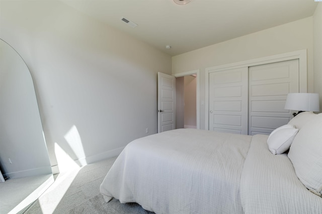 carpeted bedroom with a closet