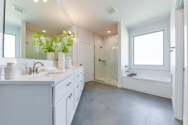 bathroom featuring tile patterned floors, vanity, and separate shower and tub