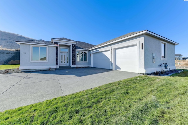 single story home with a garage and a front yard