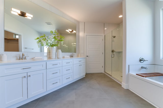 bathroom featuring plus walk in shower, tile patterned floors, and vanity