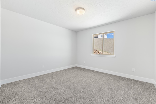 carpeted empty room with baseboards