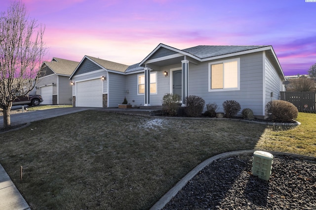 single story home with concrete driveway, a yard, roof with shingles, and an attached garage