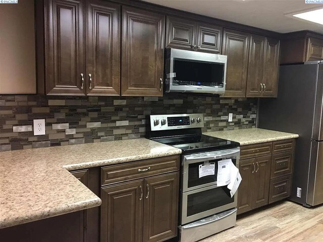 1529 Mcpherson Ave, Richland, WA 99352 - kitchen featuring dark brown cabinets, light countertops, backsplash, and stainless steel appliances
