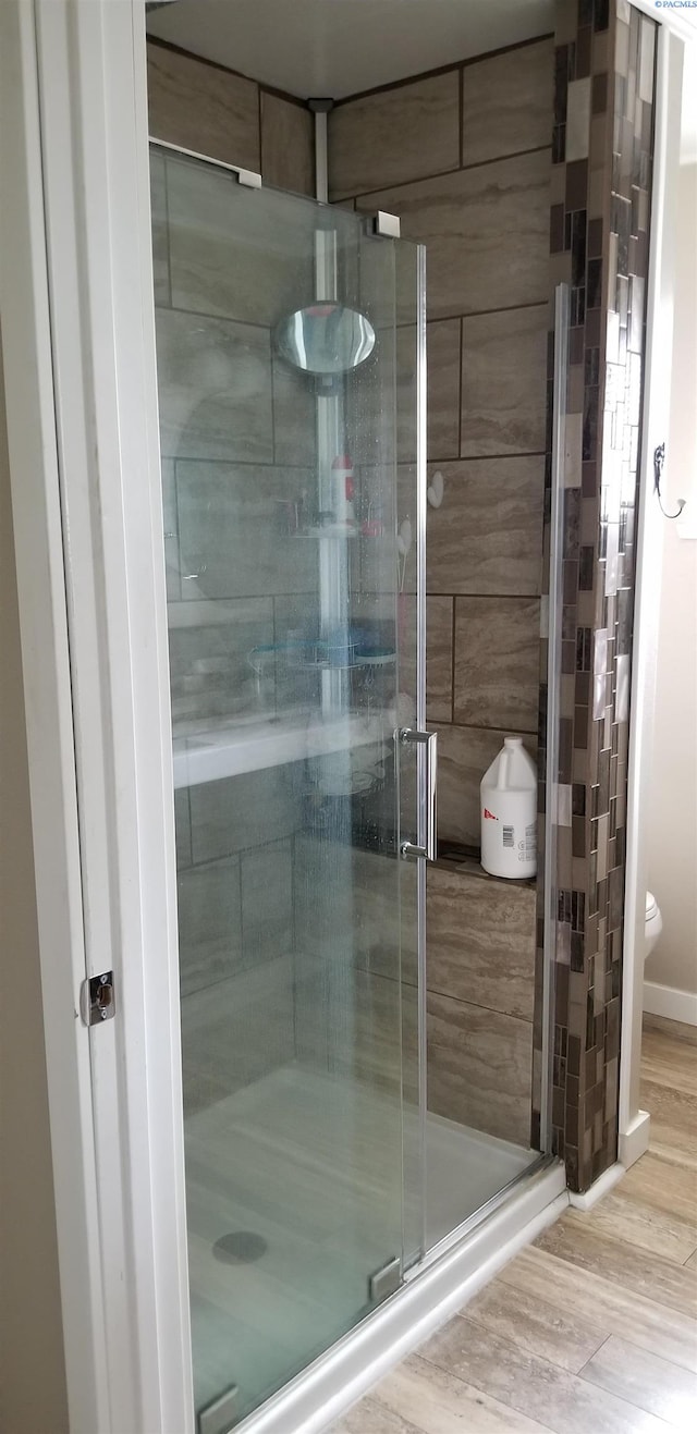 1529 Mcpherson Ave, Richland, WA 99352 - full bathroom with baseboards, wood finished floors, toilet, and a shower stall