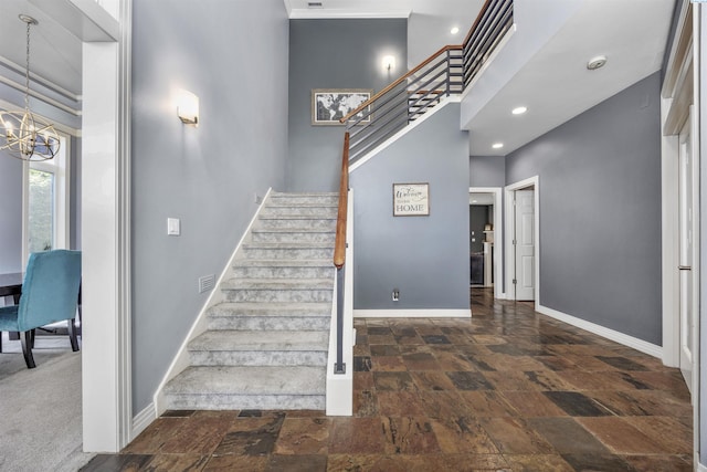 3501 W 42nd Ave, Kennewick, WA 99337 - stairway featuring baseboards, stone finish floors, a towering ceiling, a chandelier, and recessed lighting