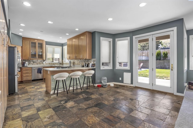 3501 W 42nd Ave, Kennewick, WA 99337 - kitchen featuring stainless steel appliances, a peninsula, tasteful backsplash, light countertops, and recessed lighting