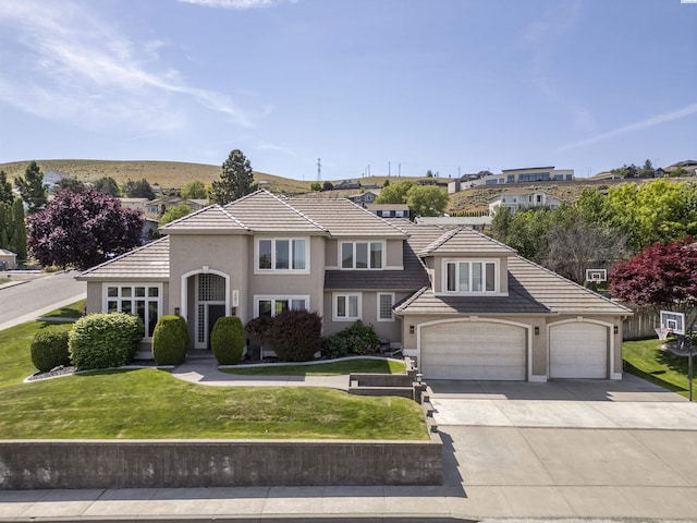 3501 W 42nd Ave, Kennewick, WA 99337 - view of front facade with driveway, stucco siding, a front lawn, and a tiled roof