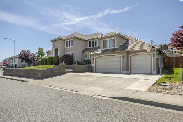 3501 W 42nd Ave, Kennewick, WA 99337 - view of front of house featuring a tiled roof, stucco siding, driveway, fence, and an attached garage