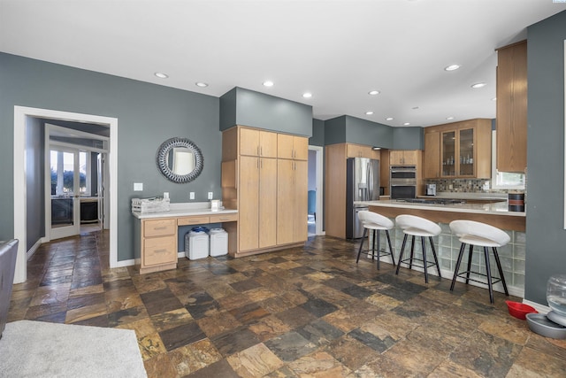 3501 W 42nd Ave, Kennewick, WA 99337 - kitchen with stainless steel fridge with ice dispenser, a peninsula, recessed lighting, tasteful backsplash, and a kitchen bar