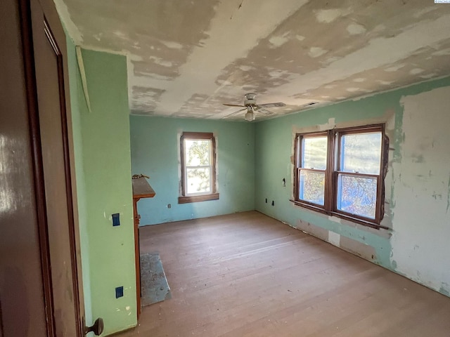 spare room featuring ceiling fan and light hardwood / wood-style flooring