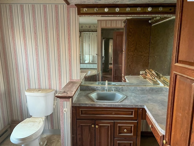 bathroom featuring vanity, a baseboard heating unit, and toilet