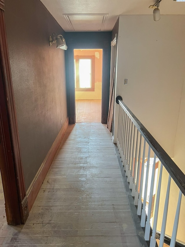 hallway with hardwood / wood-style flooring