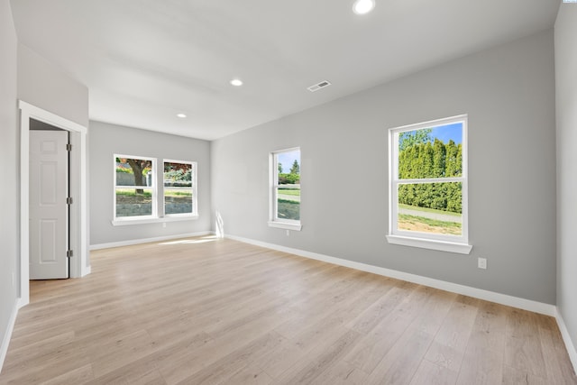 spare room featuring a wealth of natural light, recessed lighting, and baseboards