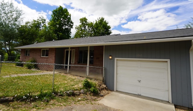 single story home featuring a garage and a front lawn