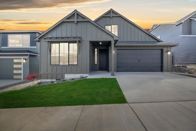 view of front of property featuring a garage and a lawn